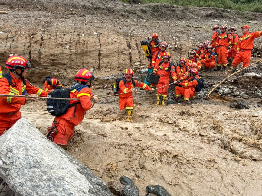 8月8日下午，受強降雨影響，榆中縣馬蓮灘村五社道路損毀嚴重，消防救援力量正在通過繩索橫渡前往救援。甘肅消防供圖